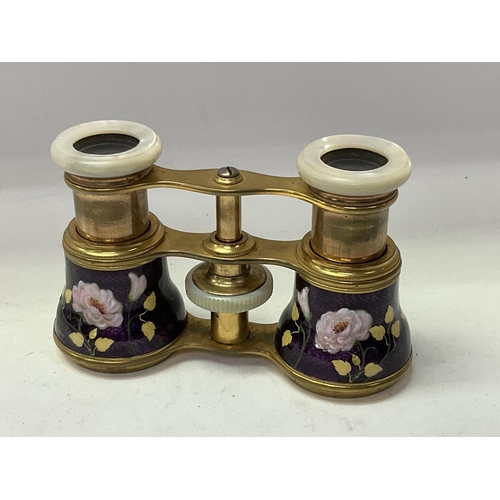 719 - A pair of French enamelled opera glasses with mother of Pearl fittings. ( some unfortunate damage).