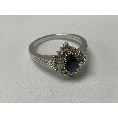 737 - A 9ct white gold central oval cut sapphire surrounded by baguette and brilliant cut stones. R.