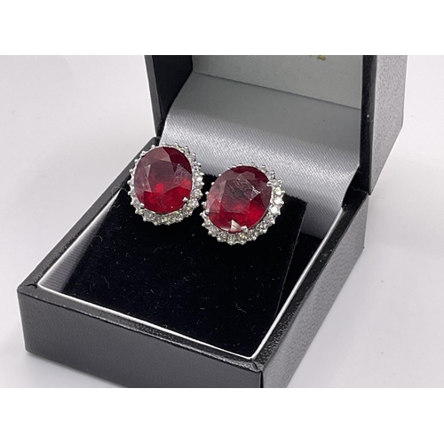 779 - A pair of 18ct white gold ruby and diamond cluster earrings. Approx 8.71ct, Diamonds 0.80ct (glass f... 