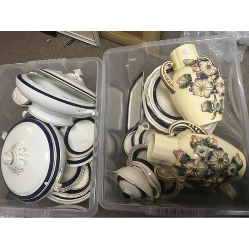 900 - Two boxes containing a dinner service and a pair of early 20th century art vases.