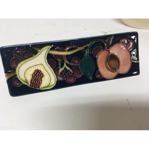 948 - A Moorcroft Pottery cabinet display sign. Length 19cm