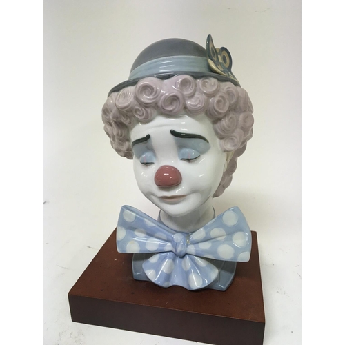 963 - A Lladro porcelain bust of a clown on a wooden plinth high 25cm