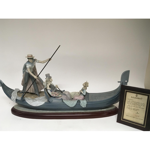 964 - A large Lladro ornament in the form of a gondola with gondolier and elegantly dressed figures the go... 