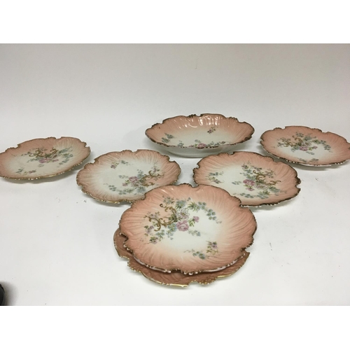 966 - A late Victorian Limoges porcelain dessert set decorated with flowers and gilt scrolls. Six plates a... 