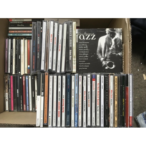 125 - A box of CDs by various artists including Miles Davis, Nirvana, Bjork and others.