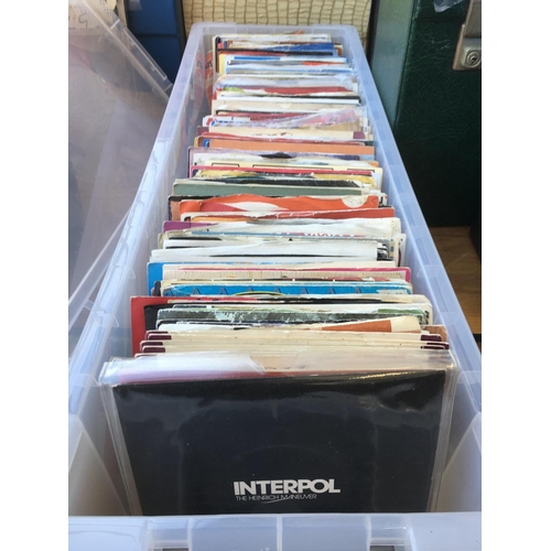 279 - A long plastic box of approx 100 plus 7inch singles by artists from the 1960s onwards.