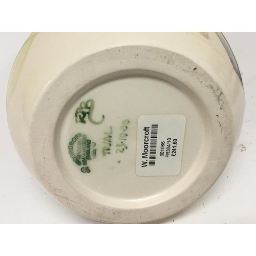 1047 - A Moorcroft vase of unusual shape decorated with orchids on a pale cream ground a trial vase dated 2... 