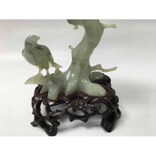 1241 - A hard Stone figure group in the form of birds on a carved base .