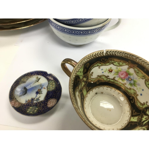 1255 - A collection of Oriental cups, saucers and dishes.