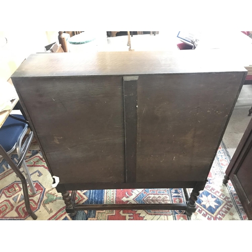 1424 - An oak bureau with a full front fitted interior Barley twist legs