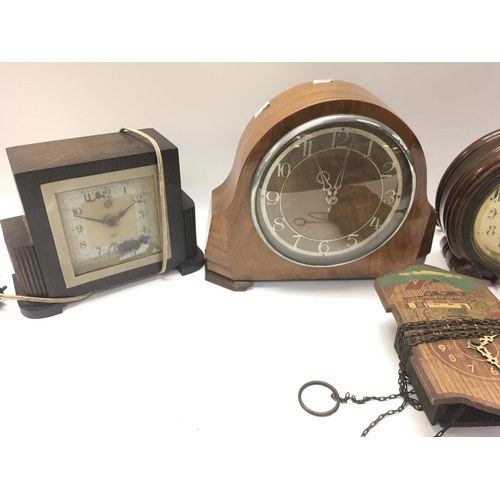 1439 - A collection of vintage clocks including an early style alarm clock.