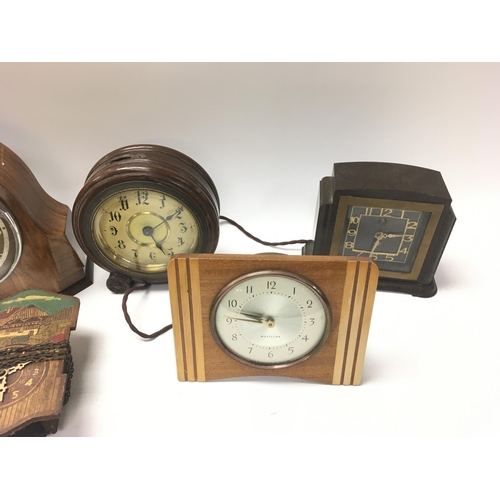 1439 - A collection of vintage clocks including an early style alarm clock.