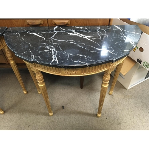 1479 - A pair of Italian carved gilt and black marble topped Demi lune tables. 90cm x 42cm x 72cm.