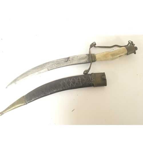 1607 - An Indian daggers with bone handle brass mounts and leather scabbard. Engraved blade. Length 31cm