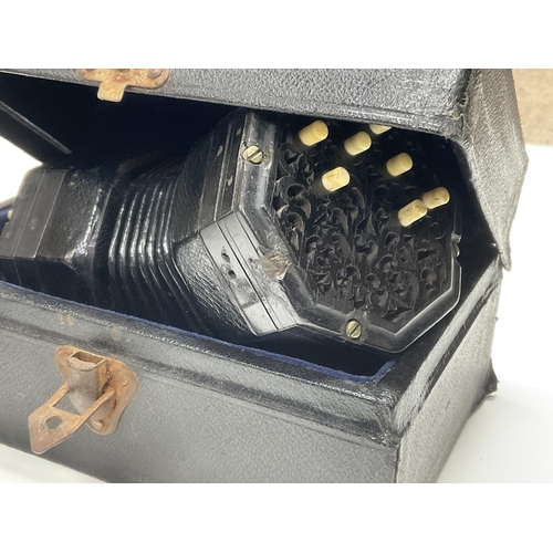 849 - 2 Whetstone miniature concertinas. 1 cased example unmarked with ebonized fretwork end panels and 13... 