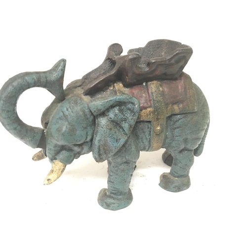 902 - A reproduction cast iron painted money box in the form of an elephant.