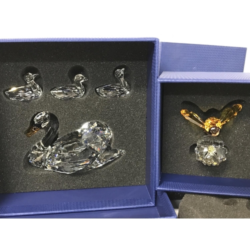 939 - Four boxed Swarovski pieces including SCS Jubilee Edition 2017, SCS Bumblebee on flower event piece ... 