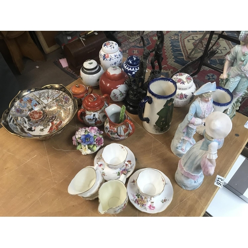 973 - A collection of ceramics, including part of tea set, Doulton figures, jugs, tea pots and a bowl.