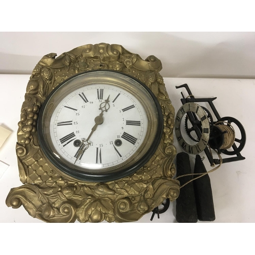 11 - A Continental metal cased wall clock and one other wrought iron clock (sold as seen) Postage Categor... 