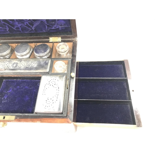 112 - An antique travelling vanity box with silver plate lids.