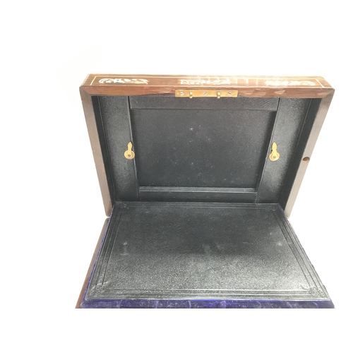 112 - An antique travelling vanity box with silver plate lids.