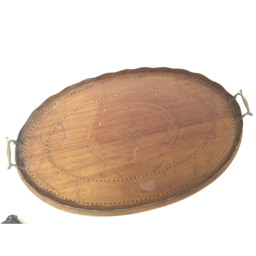 15 - An Edwardian inlaid mahogany oval butlers tray. 64cm wide postage category C NO RESERVE.