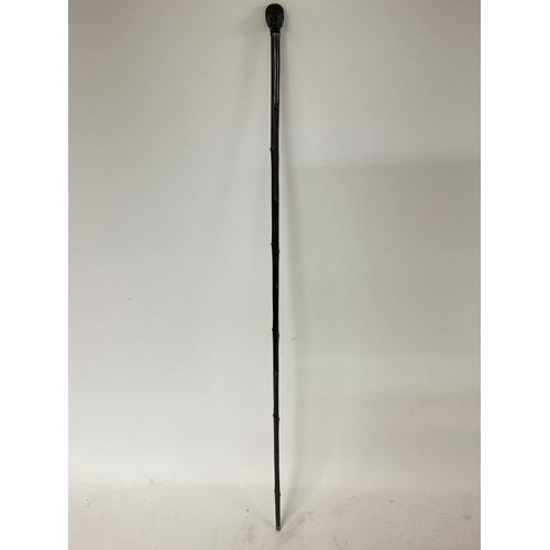 199 - Ebonized walking cane presenting a Native Africans head NO RESERVE