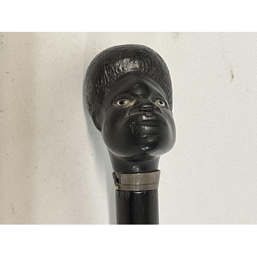 199 - Ebonized walking cane presenting a Native Africans head NO RESERVE