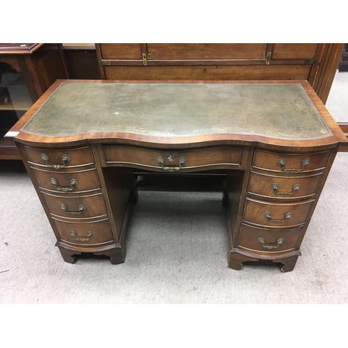 217 - A 1930s walnut veneered leather topped desk. 115 x 53 x 76cm NO RESERVE