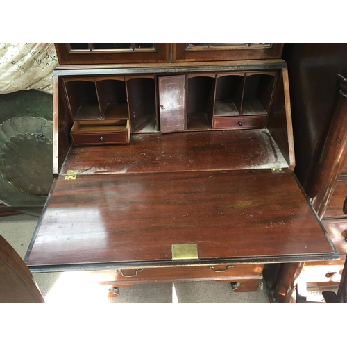 228 - A well proportioned quality Edwardian bureau bookcase with a shaped pediment above a fall front and ... 