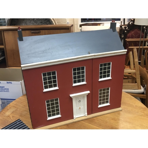 320 - No Reserve - A dolls house with a box of accessories.