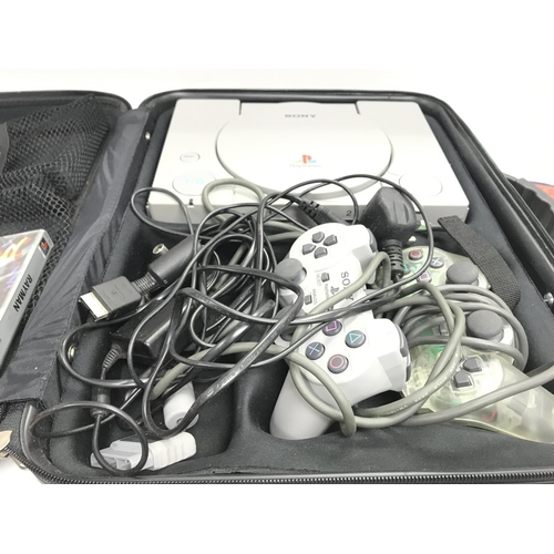 399 - A Sony PlayStation with two controllers and a number of games.