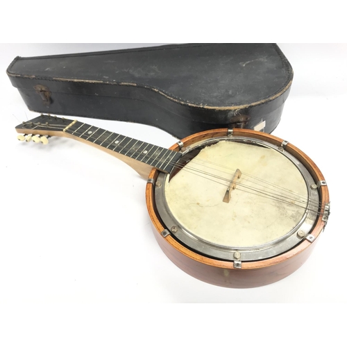 400 - A cased banjo in need of repair comes with case.