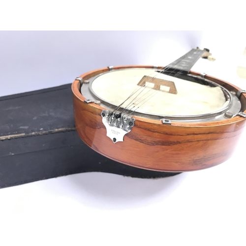 400 - A cased banjo in need of repair comes with case.