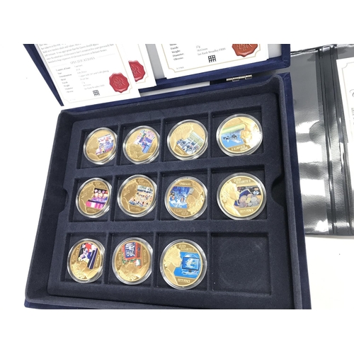 430 - 11 cased gold plated Queen Elizabeth II coins.