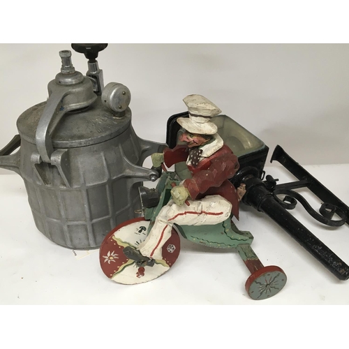 51 - A Vintage painted wooden figure on a tricycle an old metal lamp and a vintage pressure cooker.(3) po... 