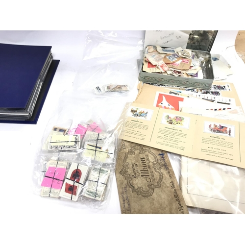 557 - A large collection of stamps and cigarette cards including several sheets of stamps