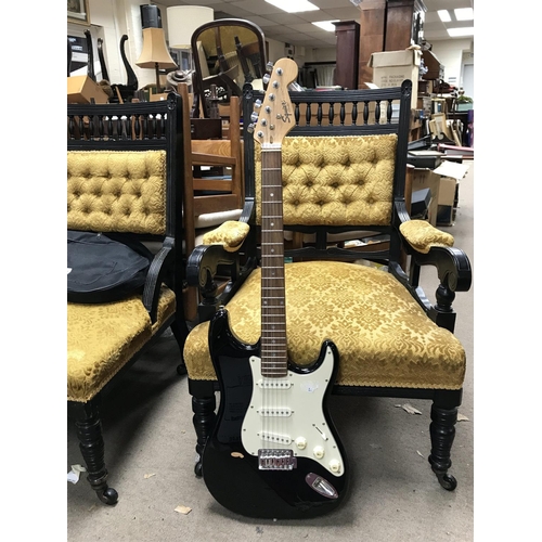 997 - Fender squire Stratocaster electric guitar in a black finish with a soft case