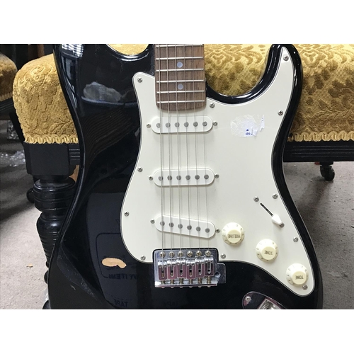 997 - Fender squire Stratocaster electric guitar in a black finish with a soft case