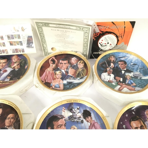 113 - A Collection of 6 Franklin Mint James Bond Collectors Plates. Playing Cards A Zippo Lighter etc.