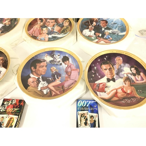 113 - A Collection of 6 Franklin Mint James Bond Collectors Plates. Playing Cards A Zippo Lighter etc.