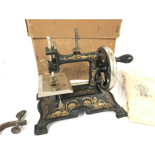 181 - A vintage Muller Childs Sewing Machine with Box And Paperwork. #15.