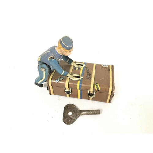 182 - A Vintage Gescha Express Tin Wind Up Button Boy. With Key.