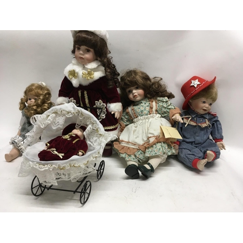 371 - A collection of four porcelain dolls one pushing pram with baby.