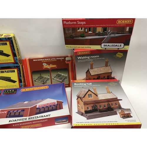 477 - A collection of boxed model railway accessories including buildings and track. Mainly Hornby 00 gaug... 