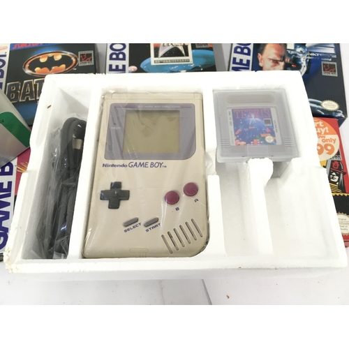 84 - A Boxed Nintendo Game Boy With 5 Games. A Game Boy Watch and a Carrycase.