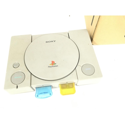 87 - A PlayStation 1 with Games and Controllers.