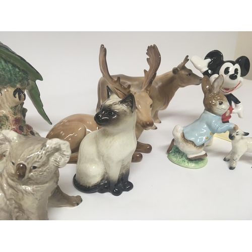1077 - Two exotic Beswick birds other Beswick animals and simulated figures.