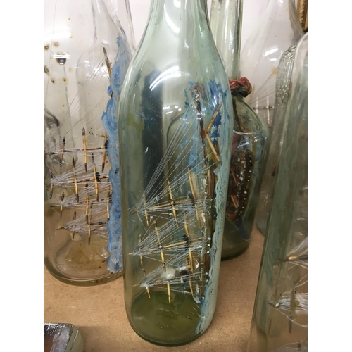 820 - A collection of glass ships in the bottles .