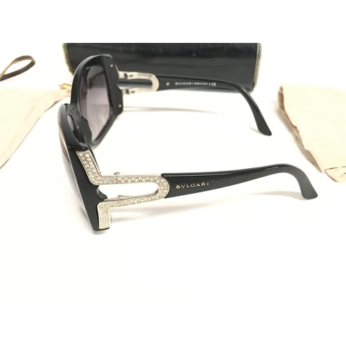 866 - A pair of ladies Bvlgari designer sun glasses with case and cloth.